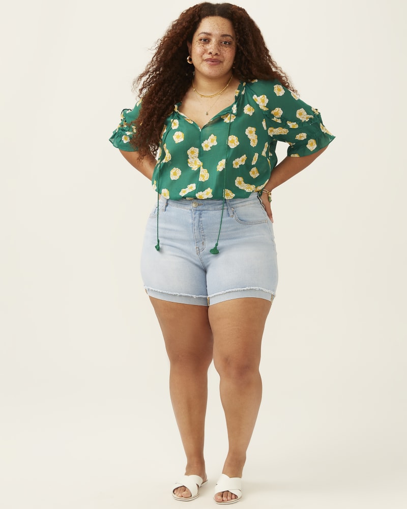 Side of 5'7.5" model wearing a plus size Regina Rolled Hem Short in Light Wash by Molly & Isadora. | dia_product_style_image_id:274201